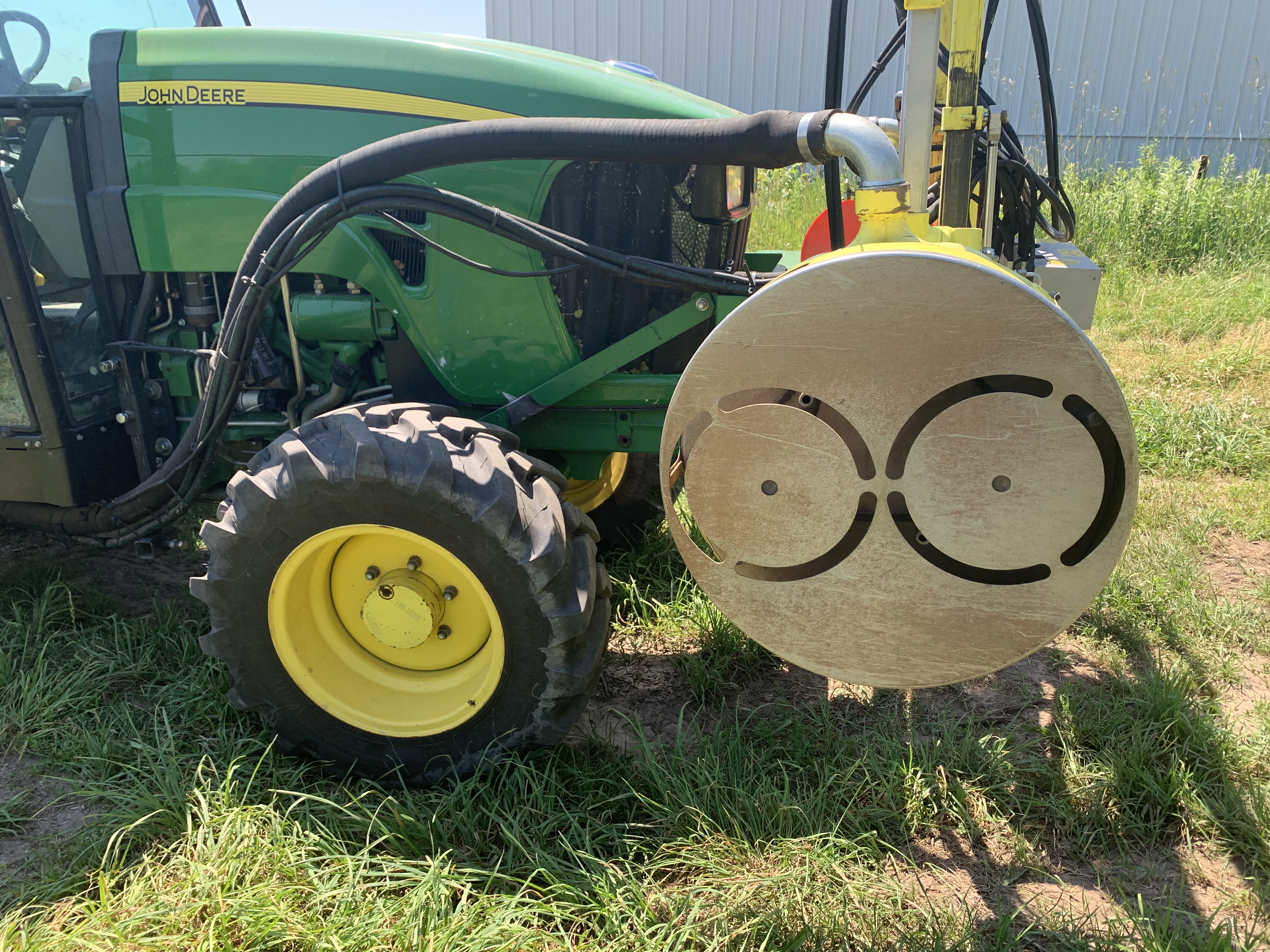 Air-pulse mechanical defoliation system mounted on a vineyard tractor, used extensively for early leaf removal in Michigan viticulture. 